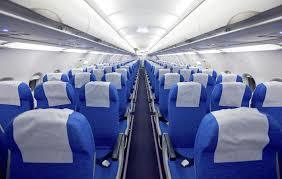 A walkway between or along sections of seats, as in a theater or a plane.