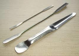 to scrape, transfer, or apply powders of solid materials